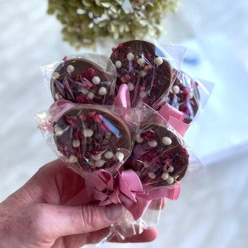 A bunch of packaged chocolate lolipops