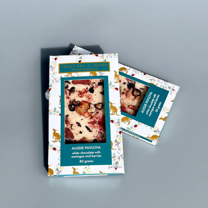 Two chocolate bars with Christmas packaging boxes on a gray background