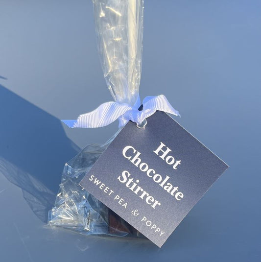 A dark hot chocolate stirrer