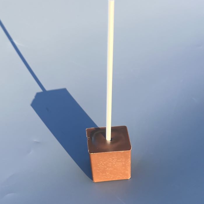 An unpackaged, milk hot chocolate stirrer